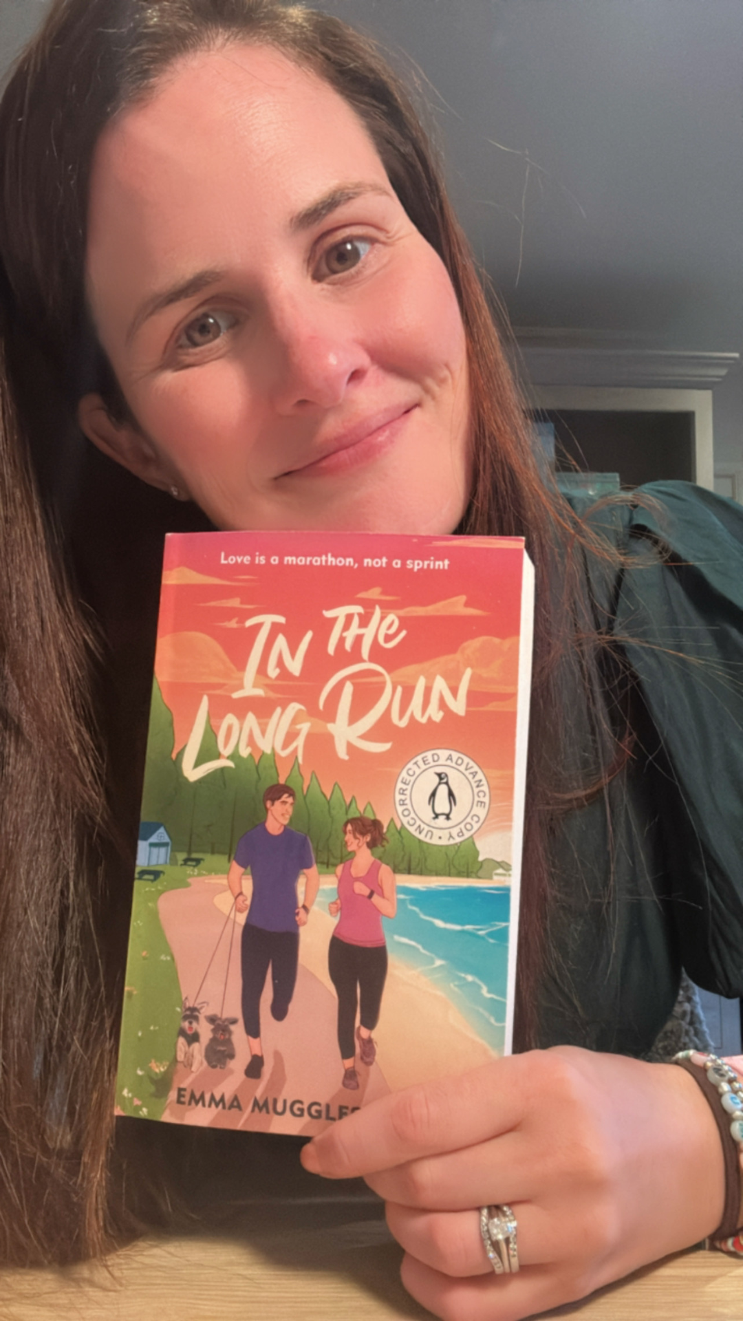 Author Emma Mugglestone holding book 'In the long run' close to camera